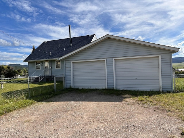 view of front of home featuring a shingled roof and fence