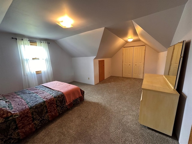 bedroom with carpet floors, a closet, and vaulted ceiling