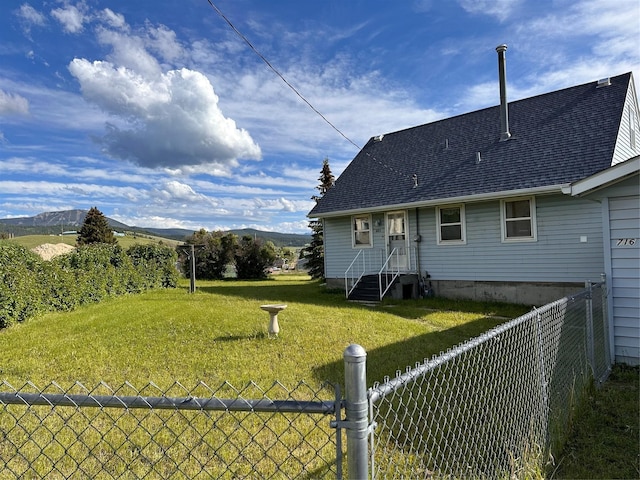 exterior space with fence and a mountain view