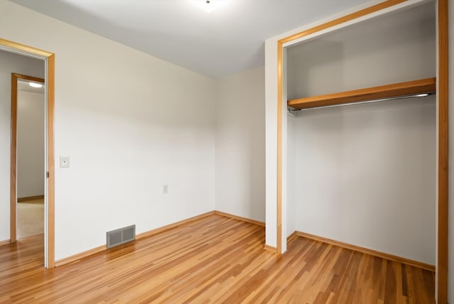 unfurnished bedroom featuring a closet and wood-type flooring