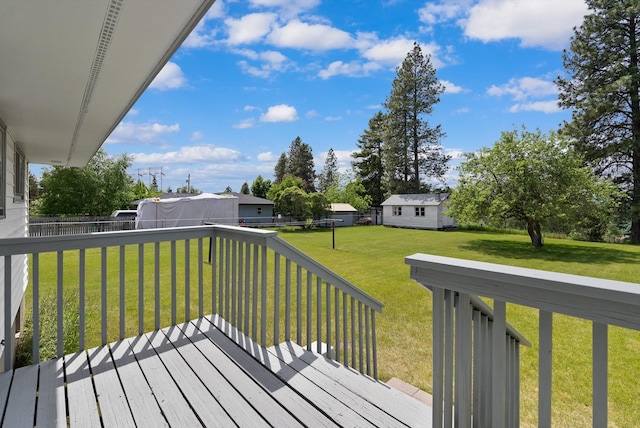 deck with a lawn and a storage unit