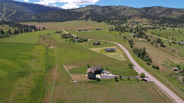 exterior space featuring a mountain view, a garage, and a front lawn