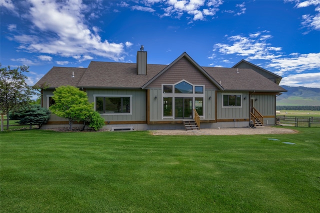 back of house with a lawn