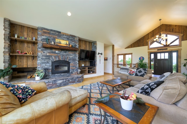 living room featuring a fireplace, built in shelves, high vaulted ceiling, a chandelier, and wood-type flooring