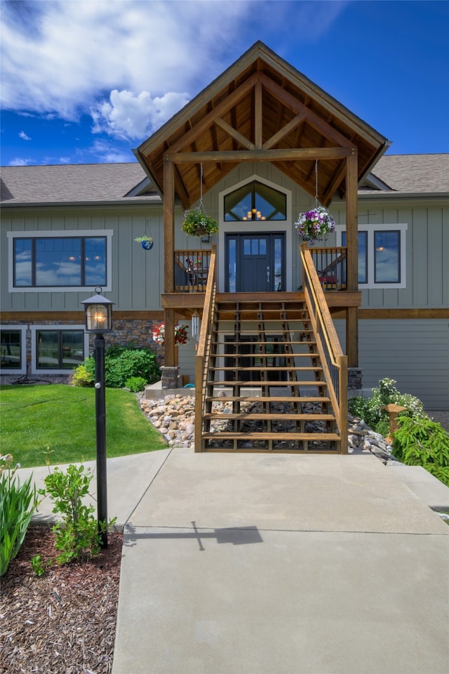 view of front facade with a wooden deck and a front lawn