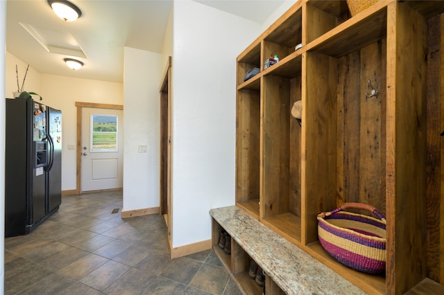 mudroom featuring dark tile patterned floors