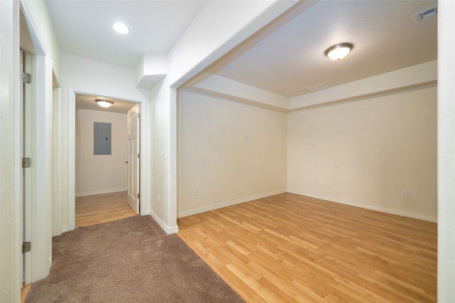 spare room with light hardwood / wood-style floors and electric panel