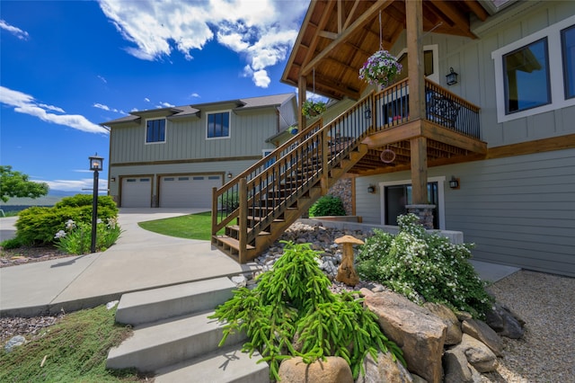 rear view of house featuring a garage and a wooden deck