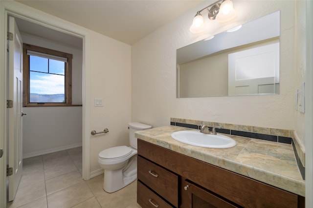 bathroom with vanity, tile patterned flooring, and toilet