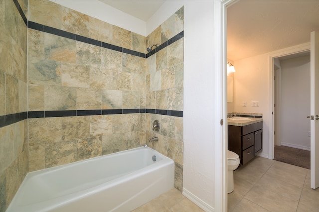 full bathroom featuring tiled shower / bath combo, vanity, tile patterned floors, and toilet