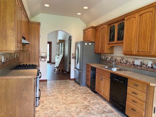 kitchen featuring gas stove, light hardwood / wood-style floors, sink, lofted ceiling, and black dishwasher