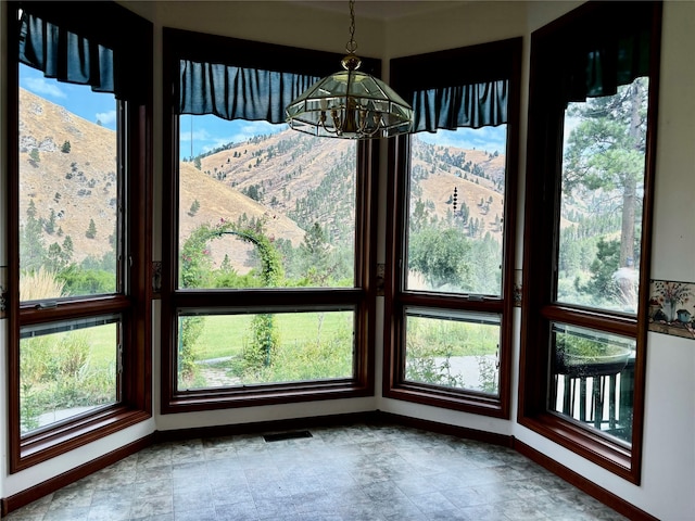 interior space with a mountain view and a notable chandelier