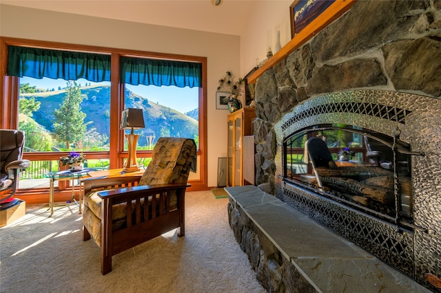 living area with a mountain view and carpet