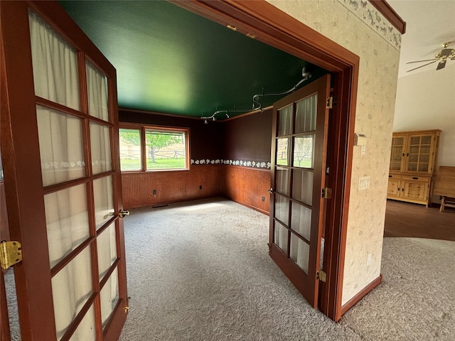 empty room with ceiling fan and carpet floors