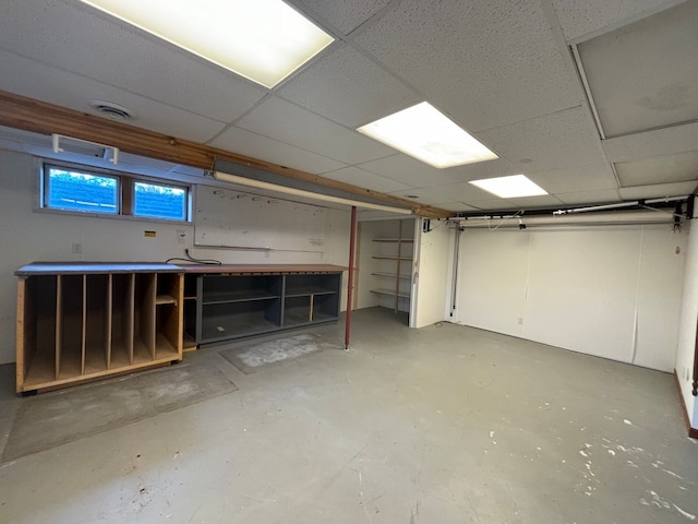 basement featuring a drop ceiling