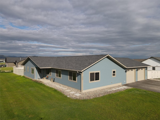 view of front of property with a garage and a front yard