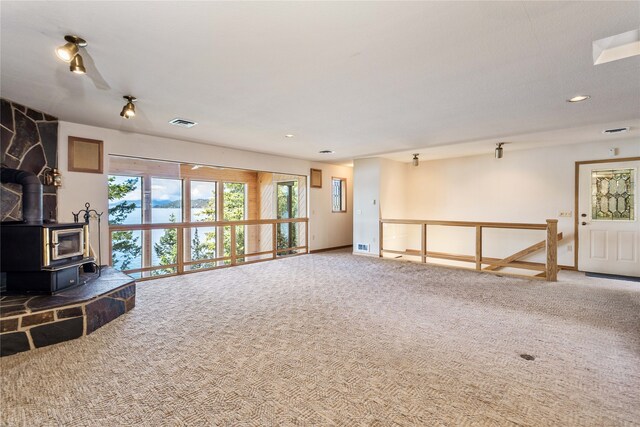 living room with a wood stove and carpet floors