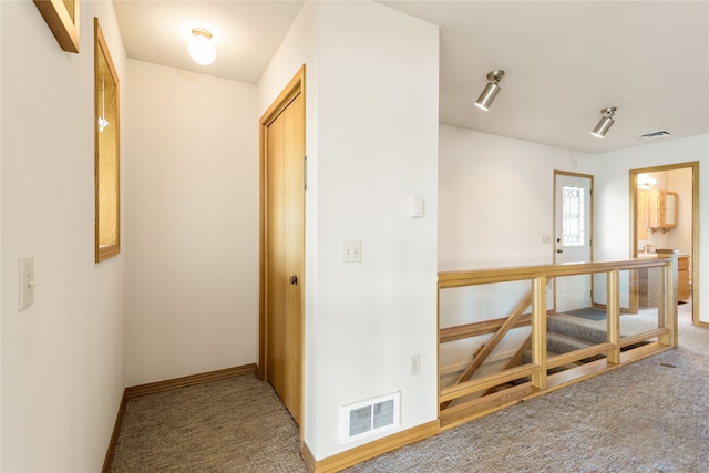 corridor with carpet flooring