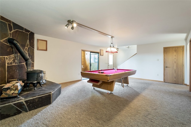 game room featuring pool table, a wood stove, and carpet floors