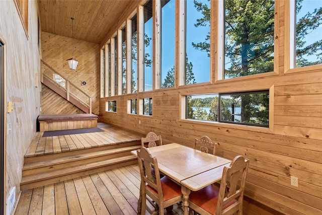 interior space with wood walls and hardwood / wood-style flooring