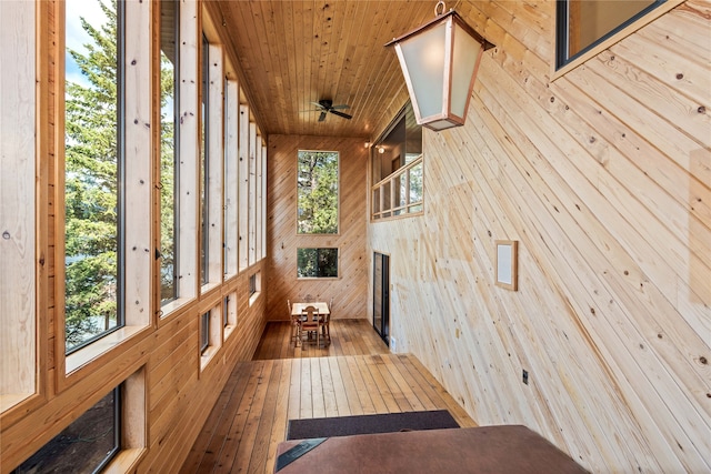 unfurnished sunroom featuring a wealth of natural light and ceiling fan