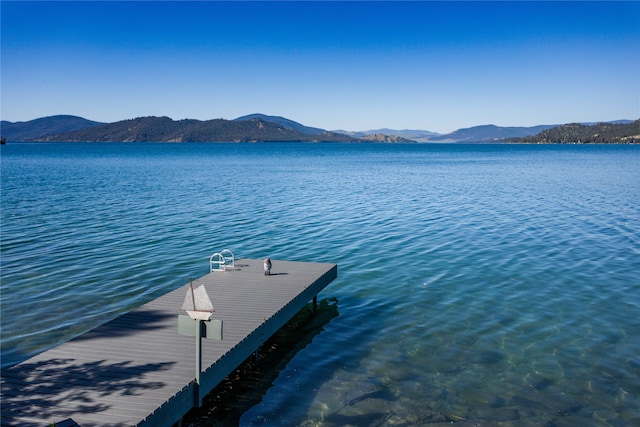 view of dock featuring a water and mountain view