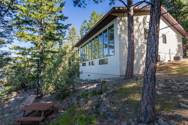 view of side of property featuring central air condition unit