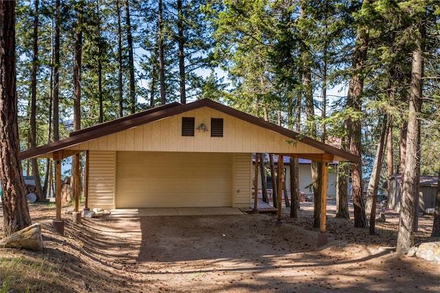 view of property exterior featuring a garage and an outdoor structure