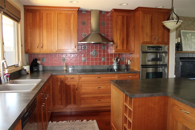 kitchen with pendant lighting, backsplash, black appliances, wall chimney range hood, and sink