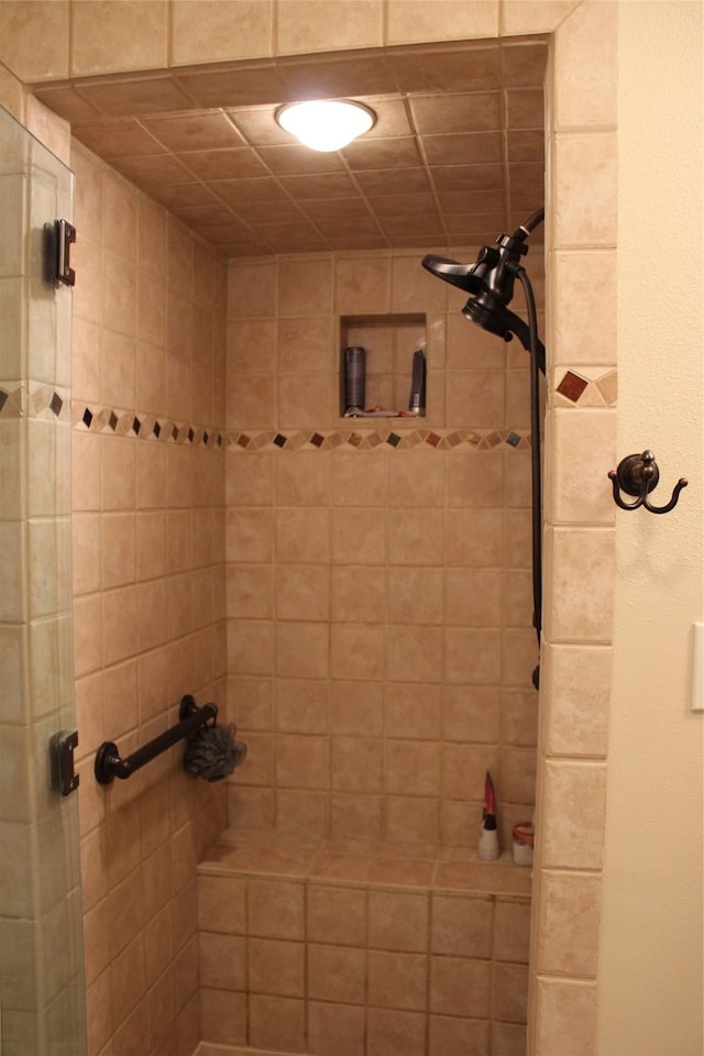 bathroom with tiled shower