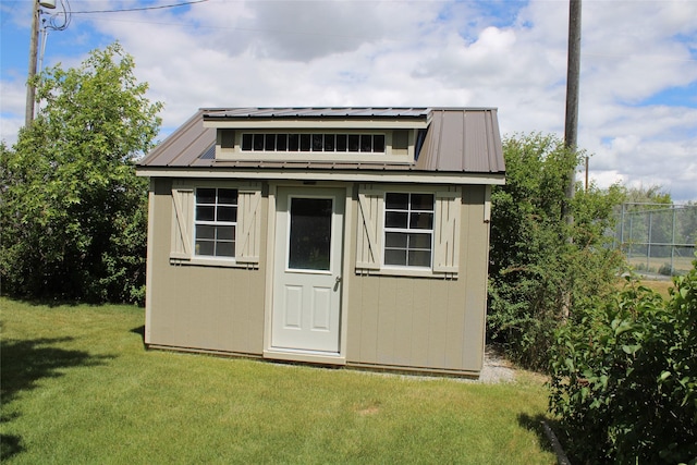 view of outdoor structure featuring a lawn