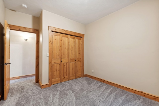 unfurnished bedroom with carpet and baseboards