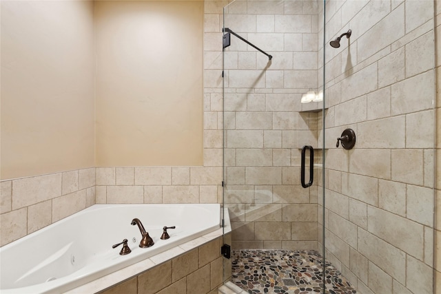 full bathroom featuring a stall shower and a garden tub