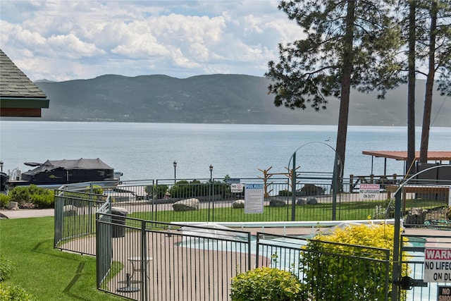 view of water feature with a mountain view and fence