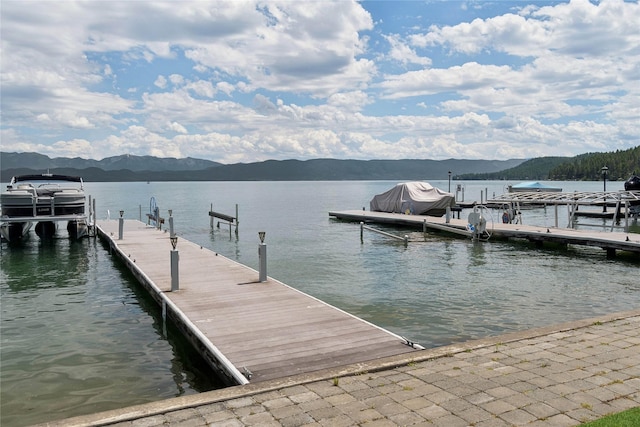 view of dock featuring a water and mountain view