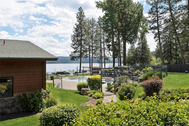 view of yard featuring a water view and fence