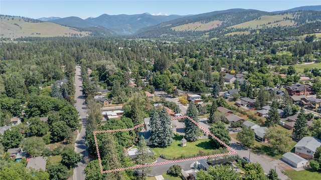 aerial view with a mountain view and a view of trees