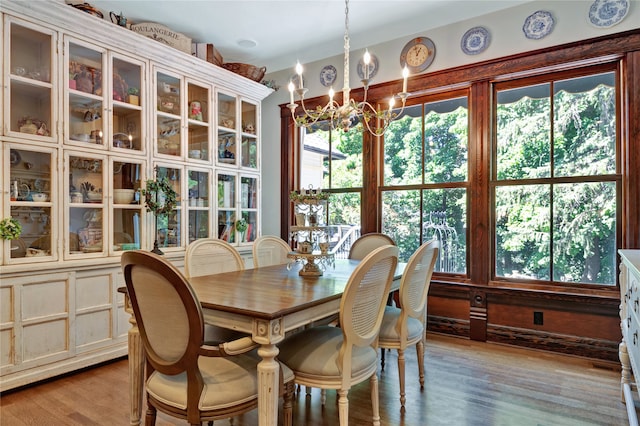 dining room featuring wood-type flooring and a chandelier