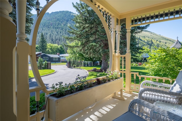 view of patio featuring a porch and a view of trees