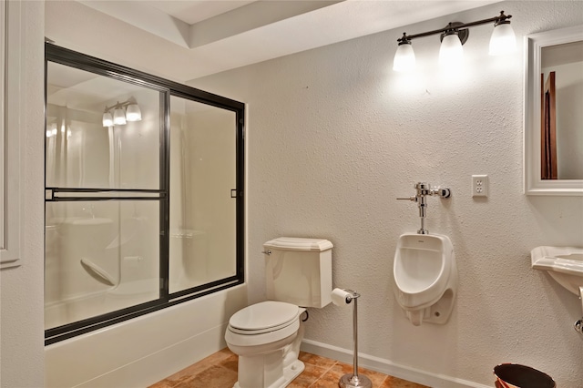 full bathroom with shower / bath combination with glass door, a textured wall, toilet, tile patterned flooring, and baseboards