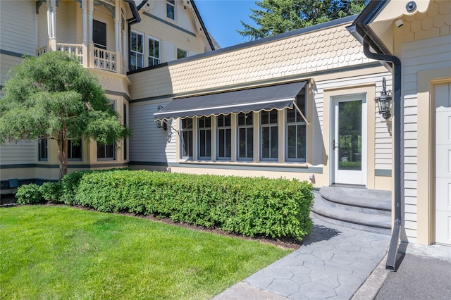 exterior space with a garage and a lawn