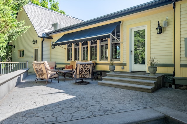 back of property with outdoor lounge area and a patio