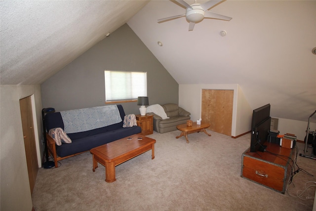 living area featuring vaulted ceiling, ceiling fan, and carpet flooring