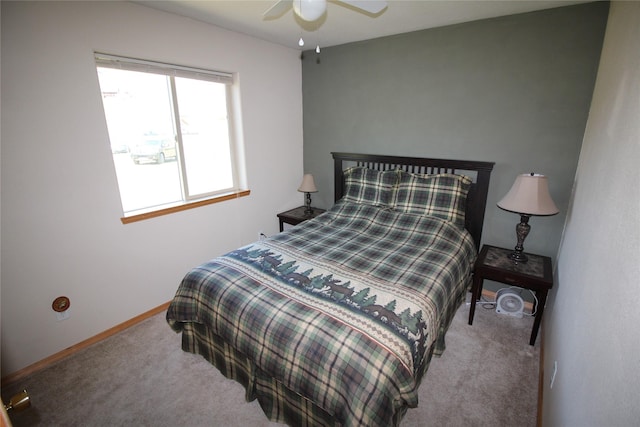 bedroom with a ceiling fan, baseboards, and carpet flooring