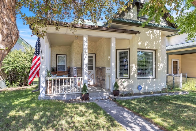 view of front of home featuring covered porch and a front yard