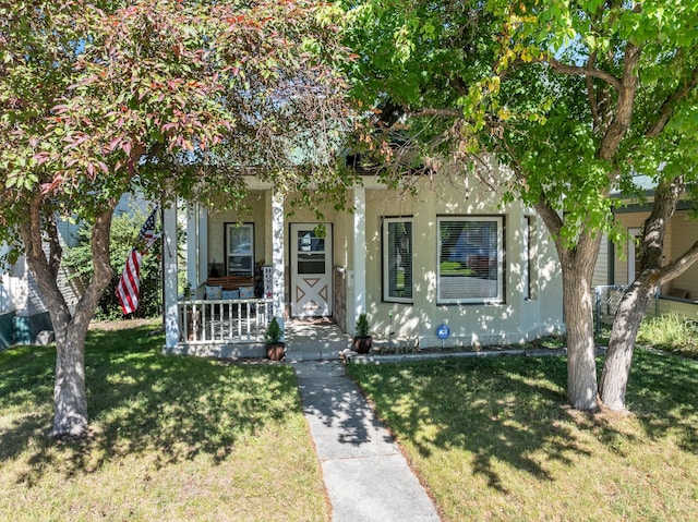 view of front of property with a front yard and a porch