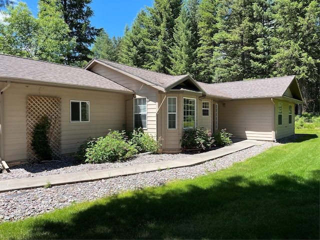 ranch-style home with a front lawn