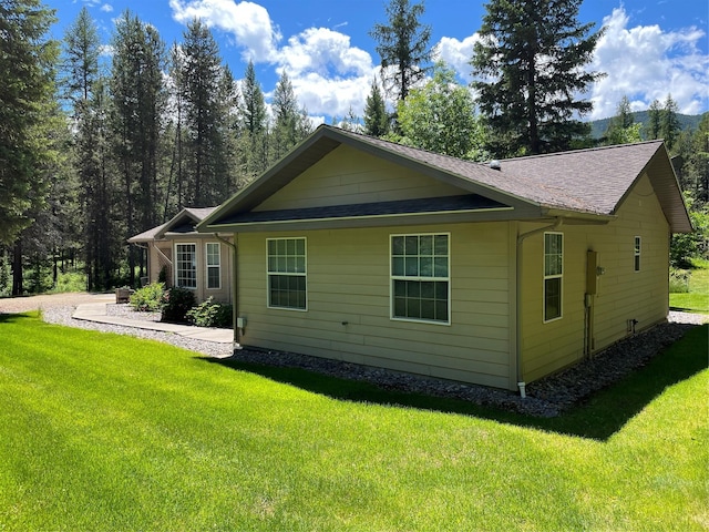 back of property featuring a lawn