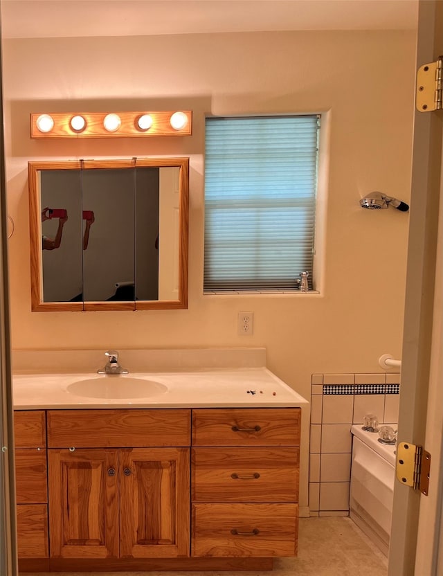 bathroom with vanity, tile patterned floors, and a tub to relax in