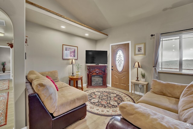living room with recessed lighting, vaulted ceiling, wood finished floors, and visible vents